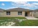 Rear exterior view of a home with a covered patio and neatly maintained lawn at 536 Squires Grove Dr, Winter Haven, FL 33880