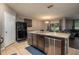 Open kitchen with an island, stainless steel dishwasher, and black refrigerator at 536 Squires Grove Dr, Winter Haven, FL 33880