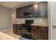 Kitchen area showcasing granite countertops, dark cabinets, and stainless steel appliances at 536 Squires Grove Dr, Winter Haven, FL 33880