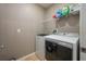 Well-lit laundry room with modern appliances and ample shelving for storage at 536 Squires Grove Dr, Winter Haven, FL 33880