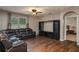 Spacious living room featuring hardwood floors, a window and a comfortable leather couch at 536 Squires Grove Dr, Winter Haven, FL 33880