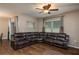 Spacious living room featuring a plush leather sectional sofa and a ceiling fan at 536 Squires Grove Dr, Winter Haven, FL 33880