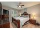 Comfortable main bedroom with a wooden bed frame, dresser, and ceiling fan at 536 Squires Grove Dr, Winter Haven, FL 33880