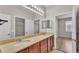 Bathroom featuring double sinks, a large mirror, vanity and a separate soaking tub at 6528 Sedgeford Dr, Lakeland, FL 33811