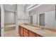 Bathroom featuring double sinks, a large mirror, vanity and a separate soaking tub at 6528 Sedgeford Dr, Lakeland, FL 33811