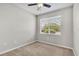 Neutral toned bedroom featuring a ceiling fan and window offering natural light at 6528 Sedgeford Dr, Lakeland, FL 33811