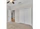 Cozy bedroom featuring a ceiling fan and closet, and a view into another room at 6528 Sedgeford Dr, Lakeland, FL 33811
