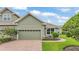 Charming townhouse with a brick driveway, a two-car garage, and well-maintained landscaping at 6528 Sedgeford Dr, Lakeland, FL 33811