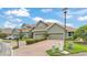 Row of townhouses with brick driveways, green lawns, and attractive landscaping at 6528 Sedgeford Dr, Lakeland, FL 33811