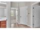 Hallway with neutral toned walls featuring a view into a bedroom and a bathroom at 6528 Sedgeford Dr, Lakeland, FL 33811