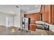 Spacious kitchen featuring stainless steel appliances, granite countertops, and wooden cabinetry at 6528 Sedgeford Dr, Lakeland, FL 33811