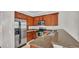 Modern kitchen featuring stainless steel appliances, granite countertops, and wooden cabinets at 6528 Sedgeford Dr, Lakeland, FL 33811