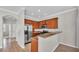 Cozy kitchen with stainless steel appliances, wood cabinets, and granite countertops at 6528 Sedgeford Dr, Lakeland, FL 33811