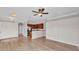 Open concept view of kitchen and living room with hardwood floors and neutral paint tones at 6528 Sedgeford Dr, Lakeland, FL 33811