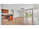 Open-concept living space with wood floors, neutral walls, and sliding glass doors at 6528 Sedgeford Dr, Lakeland, FL 33811