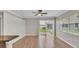 Living room featuring wood floors, a sliding glass door, and bright windows at 6528 Sedgeford Dr, Lakeland, FL 33811