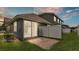 Backyard patio with brick pavers, green grass, a white fence, and a sliding glass door at 6528 Sedgeford Dr, Lakeland, FL 33811