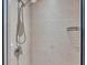 Glass enclosed shower featuring tile surround and chrome showerhead with hand wand at 6528 Sedgeford Dr, Lakeland, FL 33811