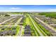 Wide aerial shot of a residential neighborhood with neatly arranged homes and a beautiful lake in the distance at 716 Vittorio Dr, Winter Haven, FL 33884