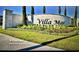 Community entrance sign for Villa Mar featuring manicured landscaping in Winter Haven, Florida at 716 Vittorio Dr, Winter Haven, FL 33884