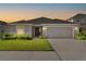 Charming single-story home featuring a well-manicured lawn, a two-car garage, and a welcoming front entrance at 716 Vittorio Dr, Winter Haven, FL 33884