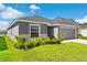 Charming single-story home with a well-manicured lawn and tidy landscaping under a sunny sky at 716 Vittorio Dr, Winter Haven, FL 33884