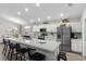 Bright kitchen features a large island, stainless steel appliances, and modern white cabinetry at 716 Vittorio Dr, Winter Haven, FL 33884