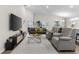 Spacious living room featuring modern furnishings, high ceilings, and sliding glass doors to the outdoors at 716 Vittorio Dr, Winter Haven, FL 33884
