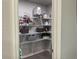 Organized walk-in pantry with white wire shelving and storage baskets for optimal kitchen organization at 716 Vittorio Dr, Winter Haven, FL 33884