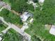 Aerial view of a property showcasing its in-ground pool, backyard, and mature landscaping at 7714 Chase Rd, Lakeland, FL 33810
