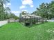 Expansive backyard featuring a screened-in pool area, shed, and a well-manicured lawn at 7714 Chase Rd, Lakeland, FL 33810