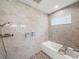 Modern bathroom featuring a tub with shower, neutral tile and wall-mounted toiletries at 7714 Chase Rd, Lakeland, FL 33810