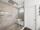 Bathroom showcasing a glass-enclosed shower, soaking tub, and decorative tile work at 7714 Chase Rd, Lakeland, FL 33810