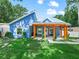 Charming blue home featuring a spacious porch with wooden beams and a well-manicured front lawn at 7714 Chase Rd, Lakeland, FL 33810