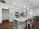 Stunning kitchen featuring marble counters, an island with seating, and stainless steel appliances at 7714 Chase Rd, Lakeland, FL 33810
