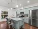 Bright kitchen features marble countertops, stainless steel appliances, and an island with bar seating at 7714 Chase Rd, Lakeland, FL 33810