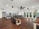 Open-concept living room and kitchen with modern finishes, stainless appliances, and a comfortable seating area at 7714 Chase Rd, Lakeland, FL 33810