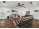 Spacious living room featuring hardwood floors, a cozy seating area, and ample natural light at 7714 Chase Rd, Lakeland, FL 33810