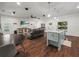 Open-concept living space with a modern kitchen island, hardwood floors, and a stylish seating area at 7714 Chase Rd, Lakeland, FL 33810
