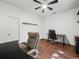 Office space features wood floors, a ceiling fan, a window, and a desk and chair at 7714 Chase Rd, Lakeland, FL 33810
