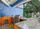 Outdoor kitchen with stainless steel appliances, a sink, a grill, and granite counters at 7714 Chase Rd, Lakeland, FL 33810