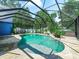 Enclosed pool with a waterfall feature and landscaped surroundings at 7714 Chase Rd, Lakeland, FL 33810