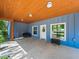 Covered porch with an inviting seating area, stylish decor, and ample natural light at 7714 Chase Rd, Lakeland, FL 33810
