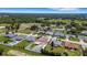 A high aerial view shows the property's location within a residential area surrounded by lush greenery at 7929 Ashley Pointe Dr, Lakeland, FL 33810