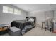 Comfortable bedroom featuring a black bed frame, stylish decor, and soft lighting at 7929 Ashley Pointe Dr, Lakeland, FL 33810