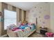 A cheerful bedroom with playful decor, perfect for , with plenty of natural light at 7929 Ashley Pointe Dr, Lakeland, FL 33810
