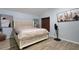 Serene bedroom with a comfortable bed, ample natural light, and wood-look tile flooring at 7929 Ashley Pointe Dr, Lakeland, FL 33810