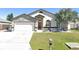Charming single-story home featuring stone accents, arched windows and a well-manicured lawn at 7929 Ashley Pointe Dr, Lakeland, FL 33810