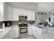 Well-lit kitchen featuring granite countertops, stainless steel appliances and white cabinetry at 7929 Ashley Pointe Dr, Lakeland, FL 33810