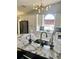 Modern kitchen featuring white cabinetry, granite countertops, stainless steel appliances, and stylish decor at 7929 Ashley Pointe Dr, Lakeland, FL 33810